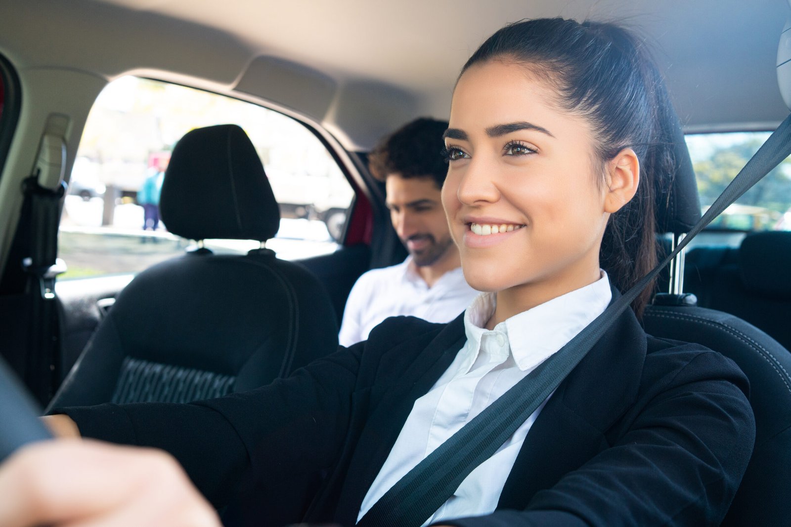 Taxi driver with passenger at back seat.